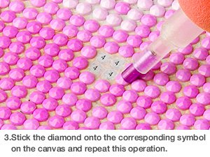 Close-up of a diamond painting kit in progress, showing pink diamonds being placed onto a canvas with a tool.