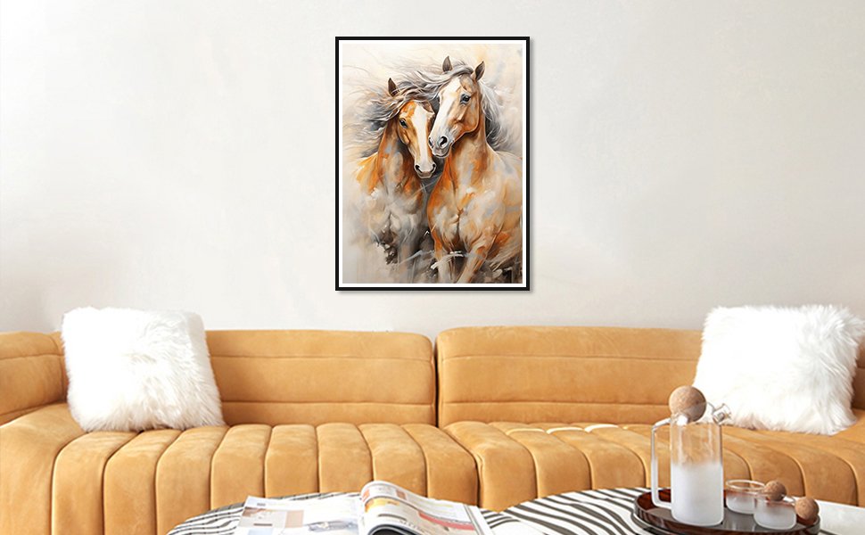 Two horses in a painterly style, framed and hanging on a wall above a sofa.