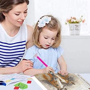 Woman and child doing a diamond painting kit featuring a horse design.