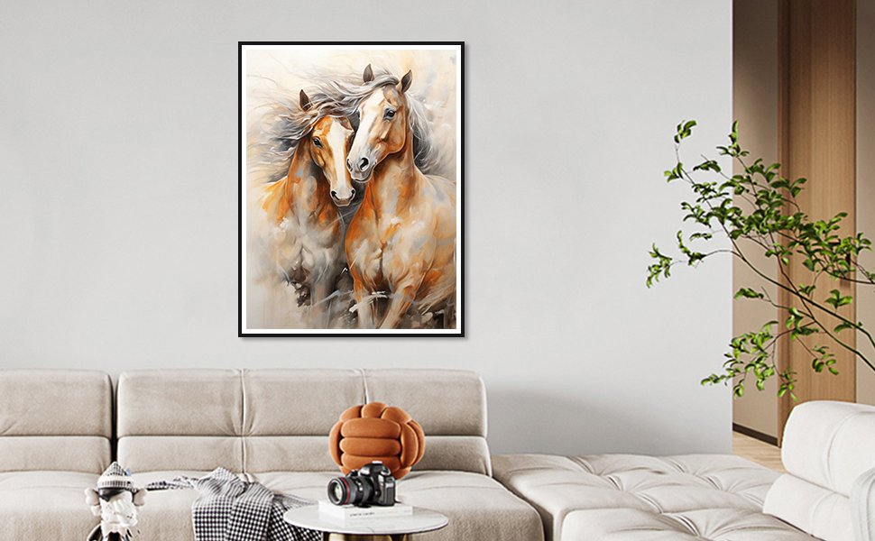 Two horses with flowing manes in a watercolor style painting, framed and hung on a wall above a sofa.