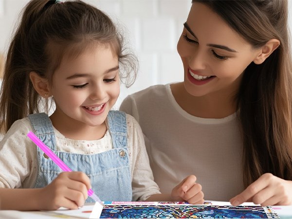 Mother and daughter smiling while doing a diamond painting kit together