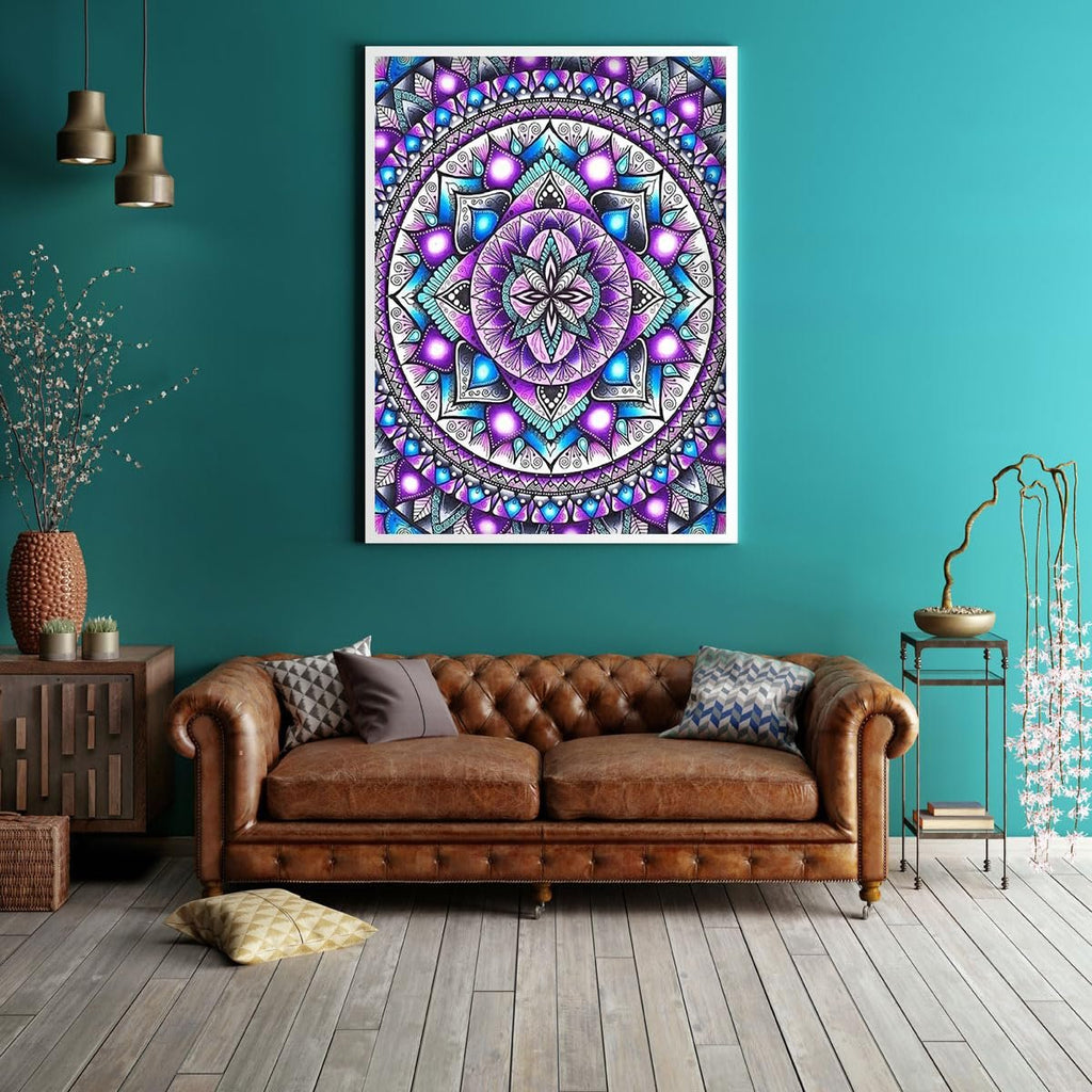 Framed mandala diamond painting artwork hanging on a teal wall above a brown leather sofa.