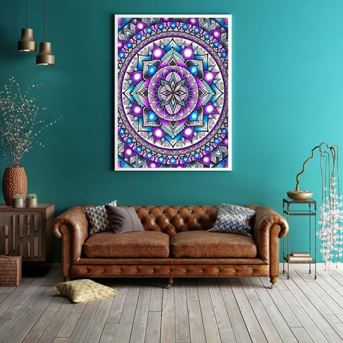 Framed mandala diamond painting artwork hanging on a teal wall above a brown leather sofa.