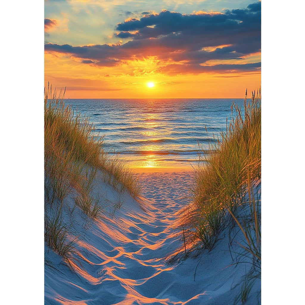 Path through sand dunes to a beach at sunset with ocean waves and dramatic clouds.