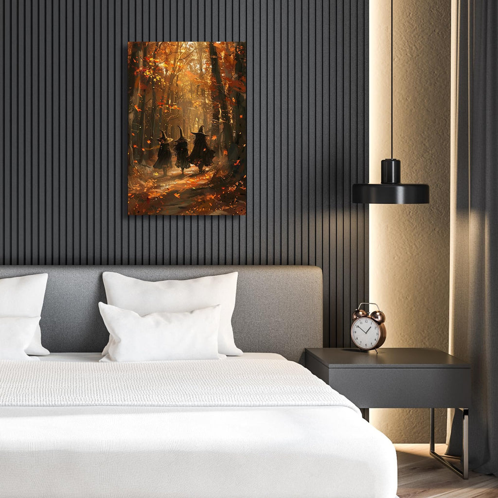 Three witches walking through a sunlit maple forest with fallen leaves, displayed as wall art above a bed.