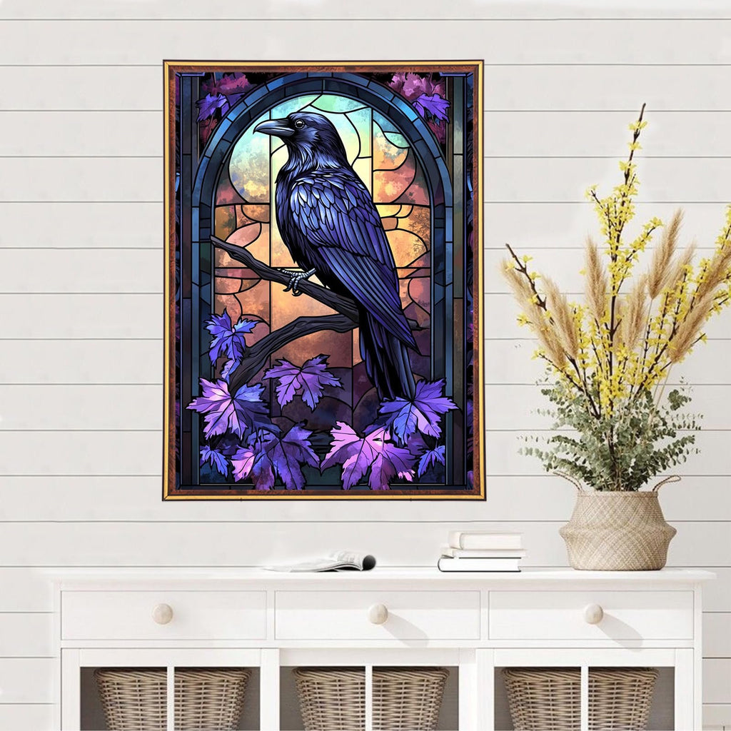 Stained glass style crow on a branch with purple leaves, framed artwork on a wall above a white dresser.