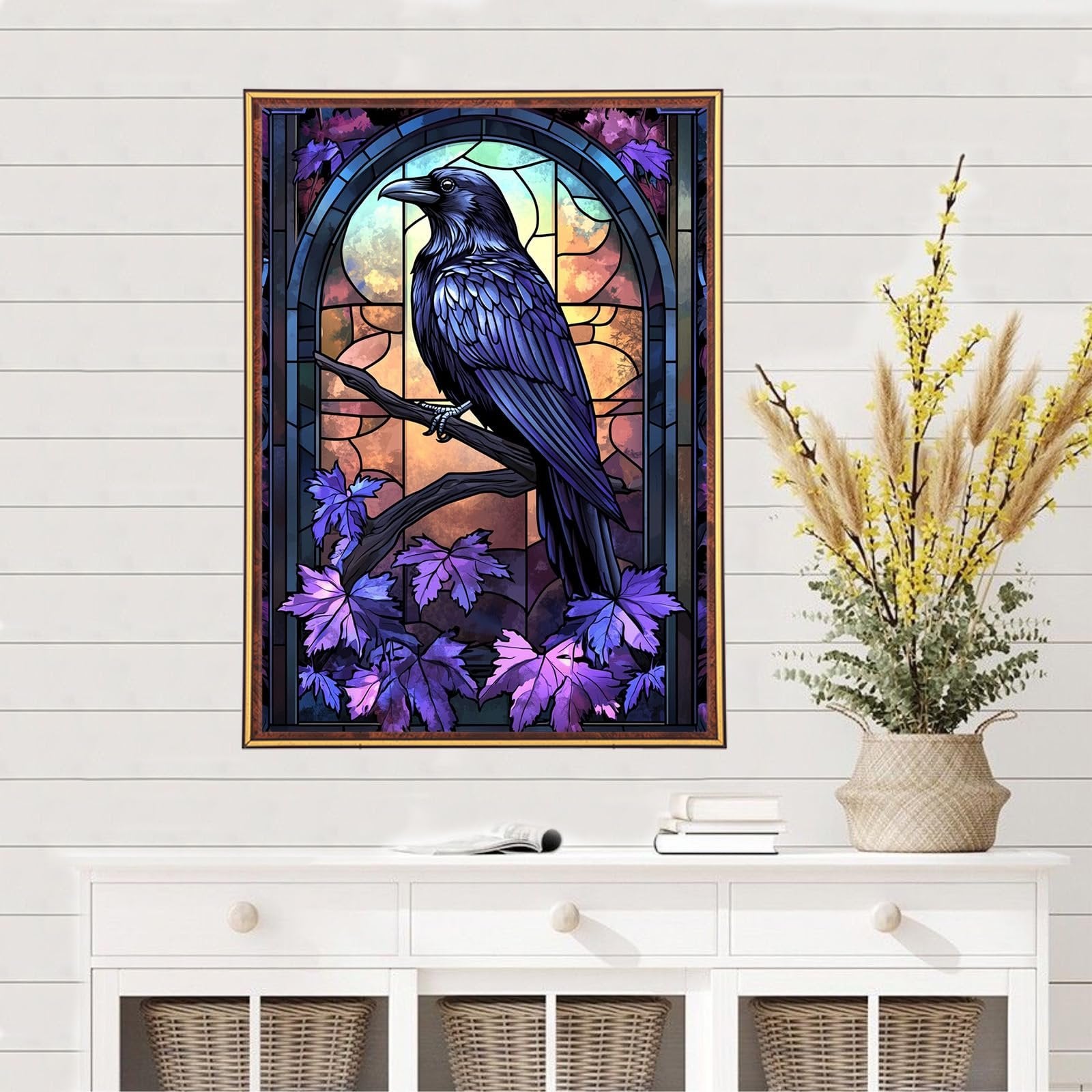 Stained glass style crow on a branch with purple leaves, framed artwork on a wall above a white dresser.