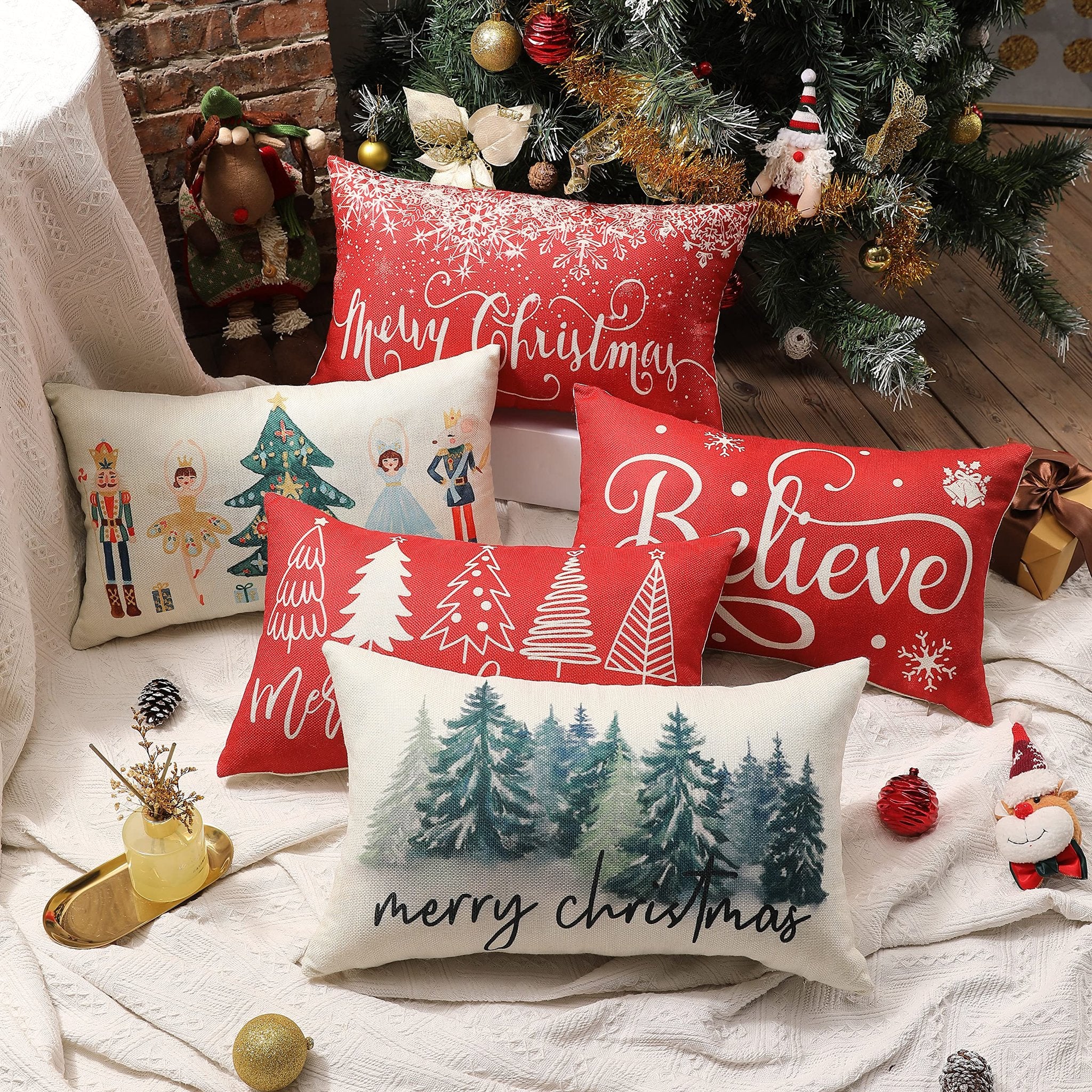 Collection of Christmas-themed lumbar pillow covers arranged around a decorated Christmas tree.