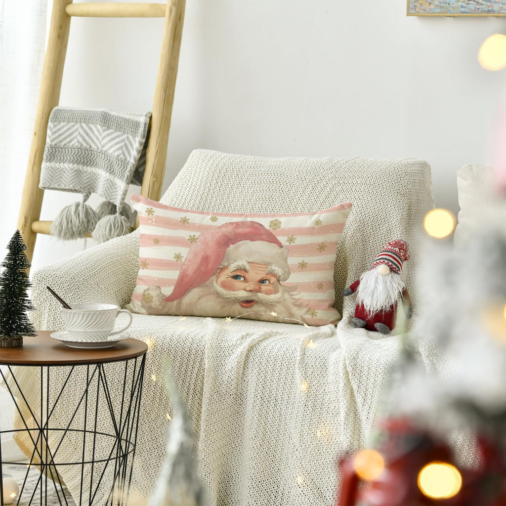Christmas throw pillow cover with Santa Claus design on a couch with a knitted blanket and decorative gnome.