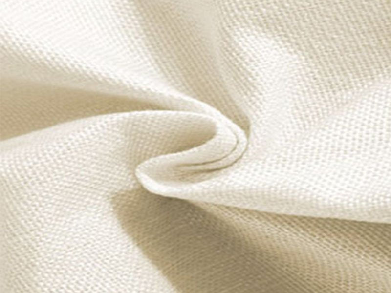 Close-up of textured beige fabric with soft folds and shadows, showing woven material detail.