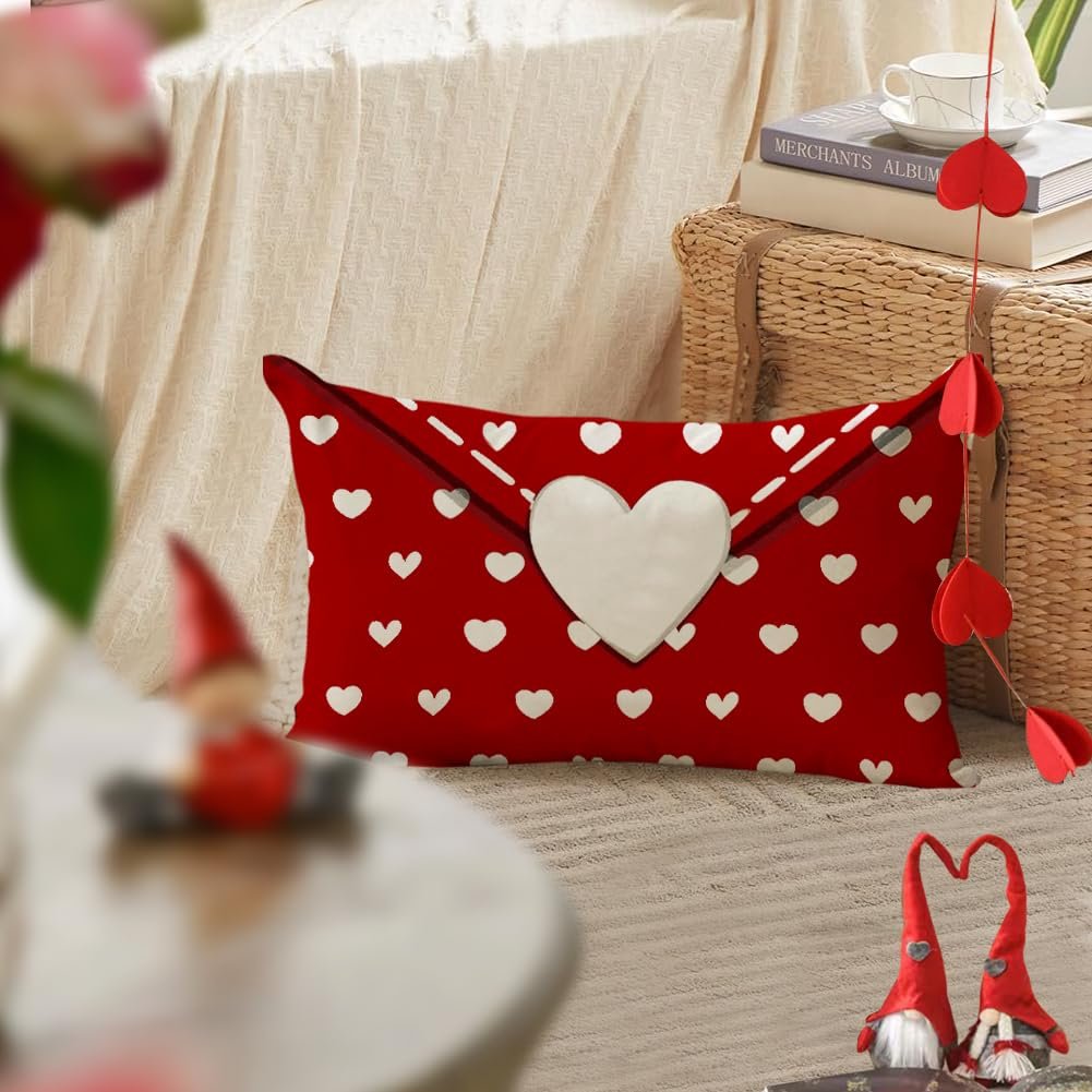 Red lumbar pillow cover with white hearts and a large white heart applique, styled as an envelope.