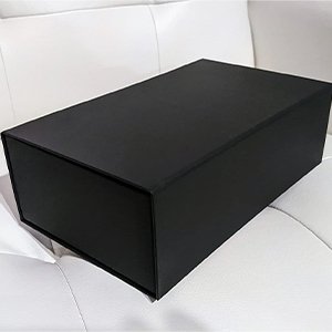 Black magnetic gift box with closure lid on a white surface