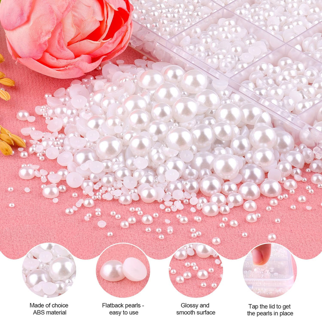 Assortment of white flatback pearls in various sizes scattered on a pink surface, with a floral accent and a divided container of pearls in the background.