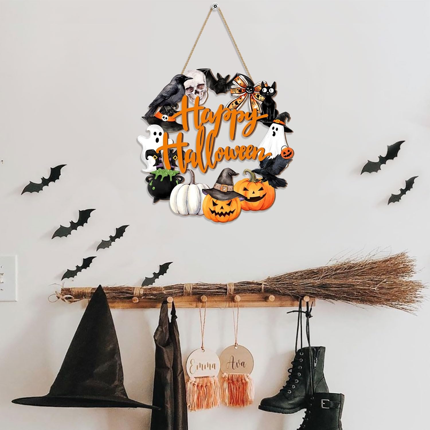 Happy Halloween wooden door sign with ghost, pumpkin, crow, skull, and cauldron decorations hanging on a wall.