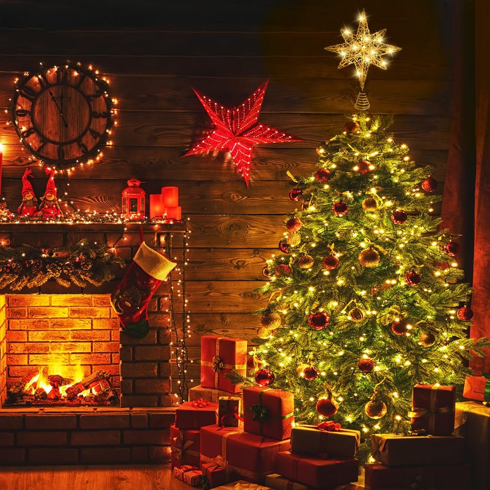 Christmas tree with a gold star topper and presents underneath, next to a fireplace with stockings and decorations.