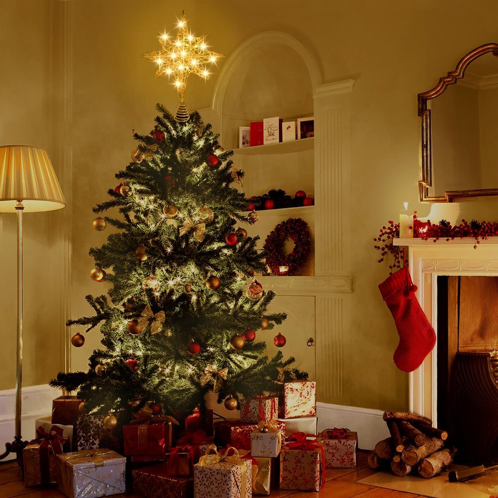 Christmas tree with a gold star topper and presents underneath, next to a fireplace.