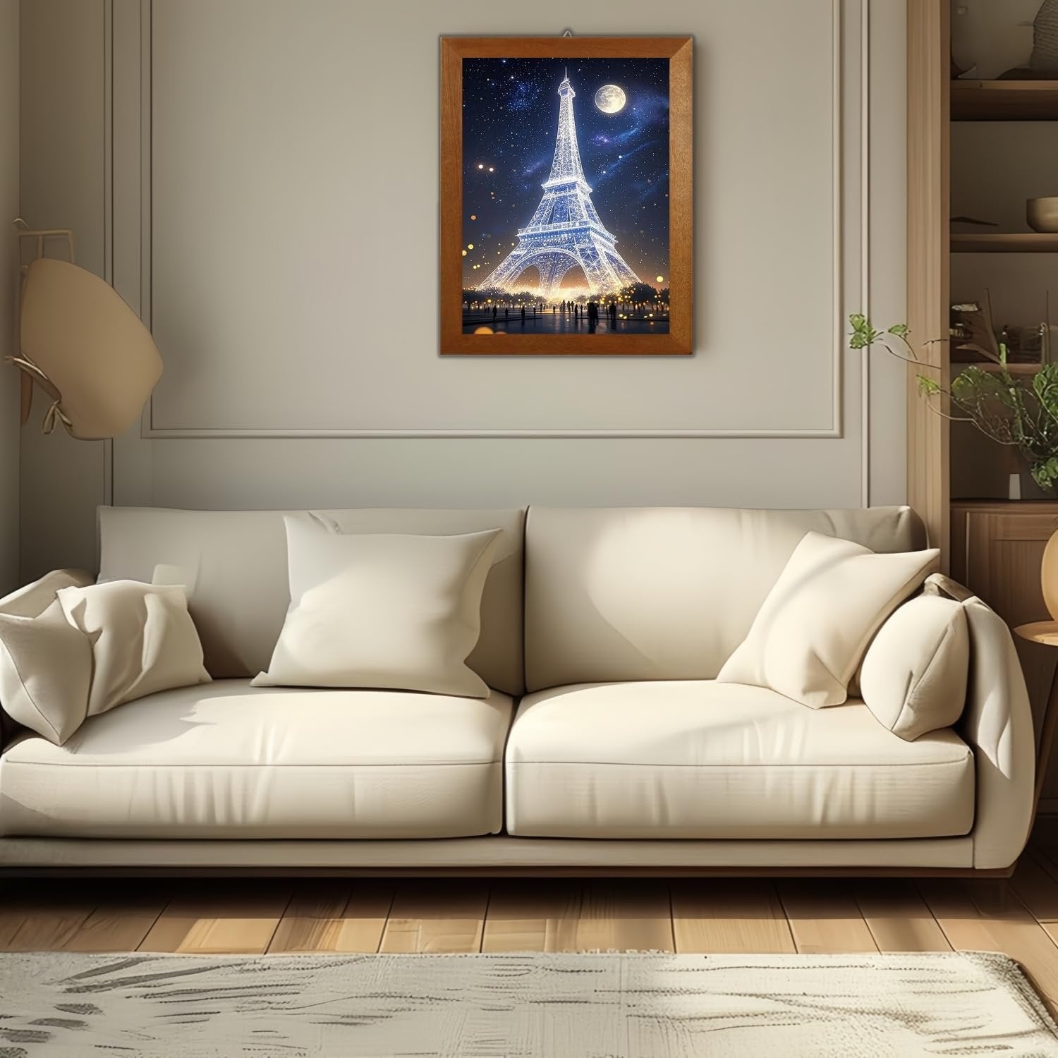 Framed diamond art painting of the Eiffel Tower at night hanging above a cream sofa.