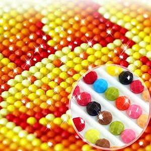 Close-up of a 5D diamond painting kit with colorful round drills, showing a magnified view of the drills.