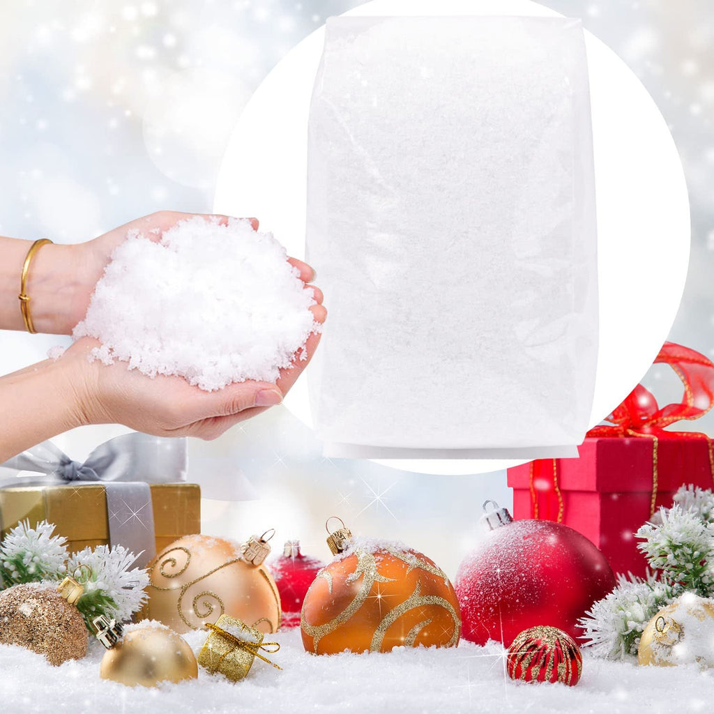 Hands holding artificial snow with Christmas ornaments and gifts in the background