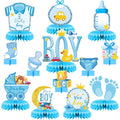 Blue honeycomb centerpieces with baby boy shower decorations including a onesie, sock, stroller, and bottle.