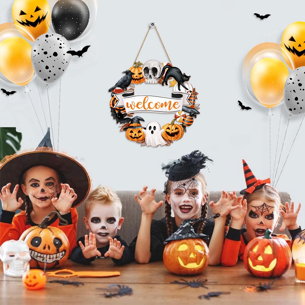 Halloween wreath sign with 'welcome' text, surrounded by pumpkins, ghosts, skulls, and bats, hanging above children in costumes.