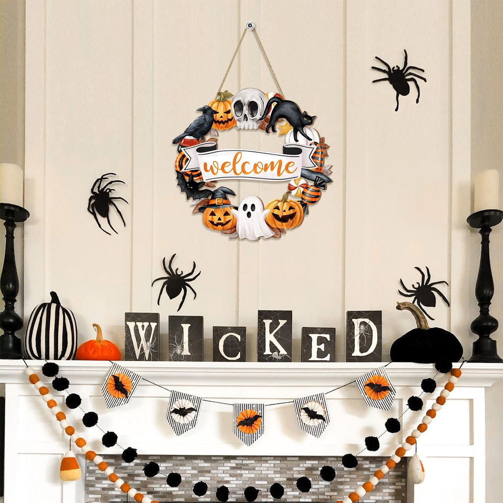 Halloween mantelpiece decorated with a wreath, spiders, pumpkins, and banners spelling 'WICKED'.