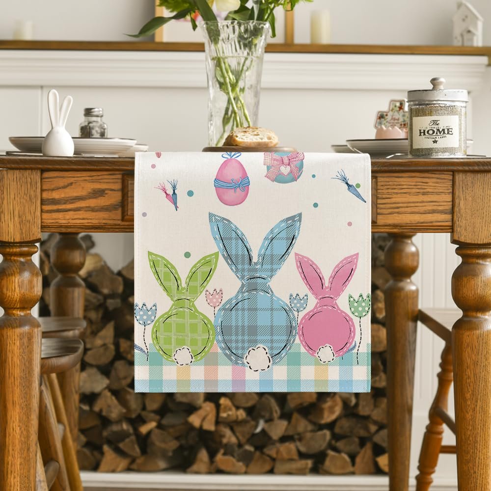 Easter table runner with plaid bunnies, eggs, and carrots on a wooden table.