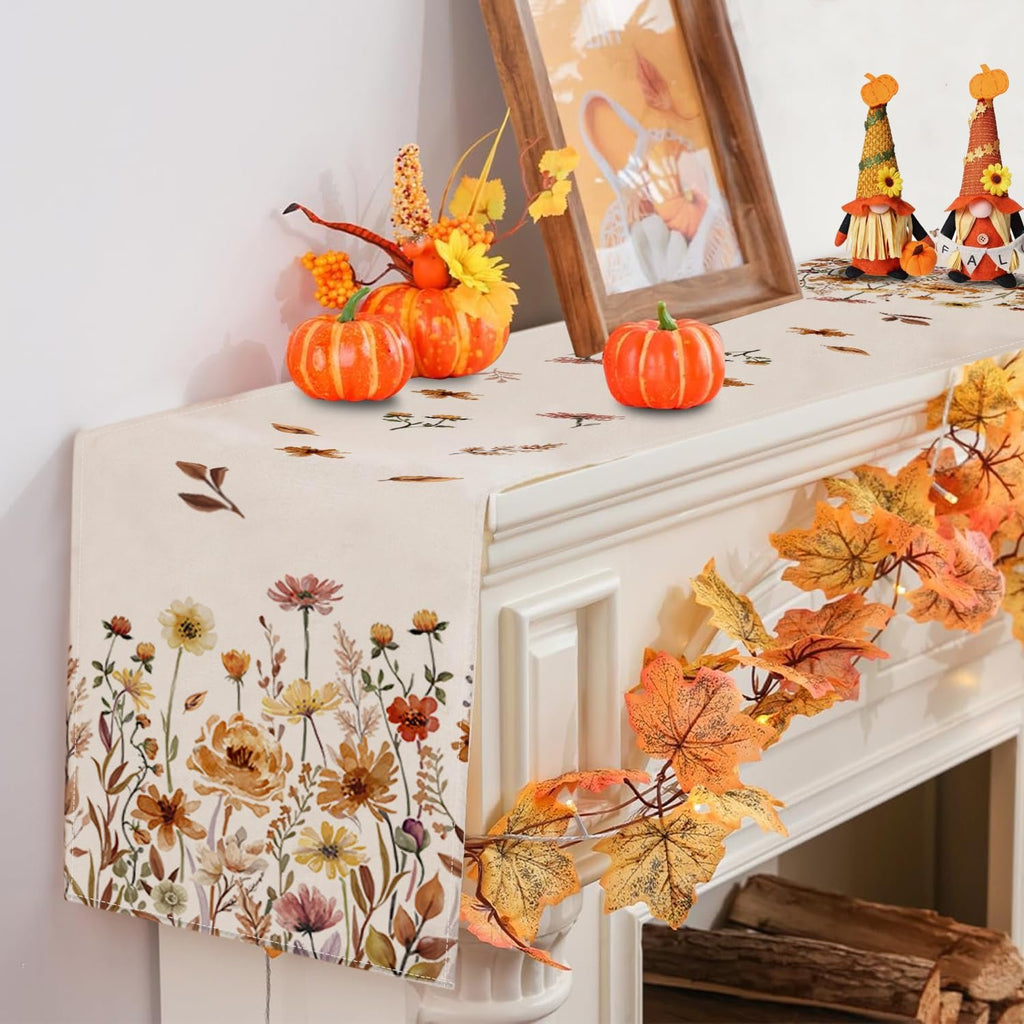 Fall floral table runner with pumpkins and autumn leaves decor on a mantelpiece