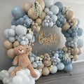 Balloon arch with a teddy bear and wooden sign that says 'We Can Bearly Wait'