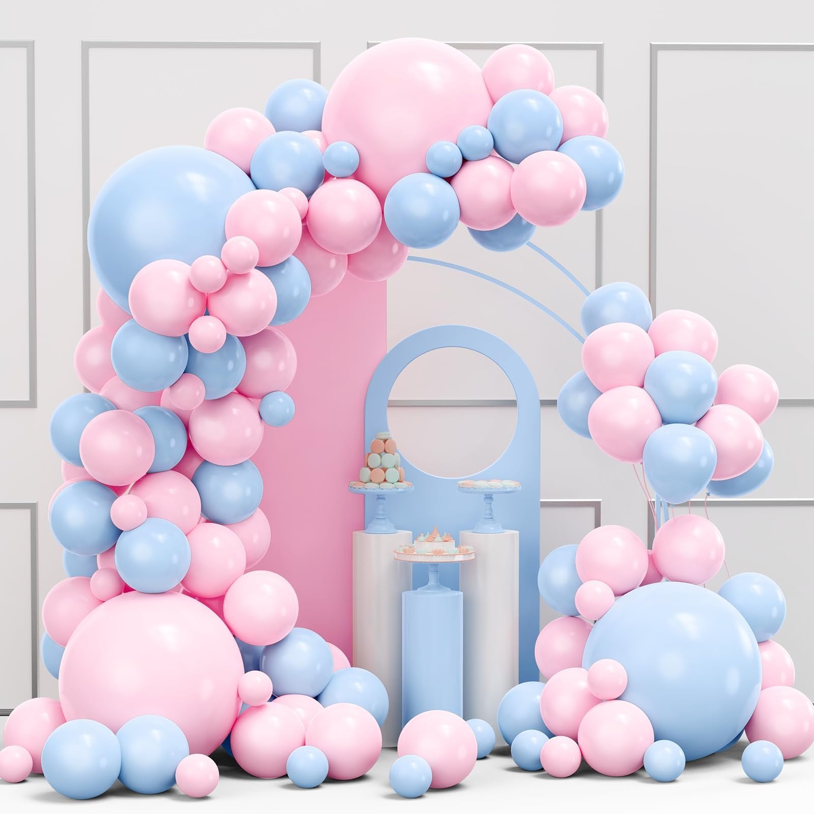 Pink and blue balloon garland arch kit with decorative cakes and macarons on pedestals