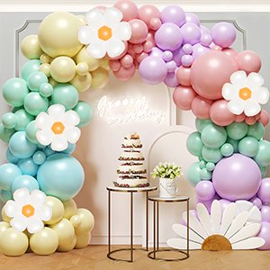 Pastel balloon arch garland with flower accents, featuring a tiered cake and floral arrangements.