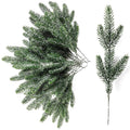Snow frosted artificial pine branches on a white background, one sprig shown separately