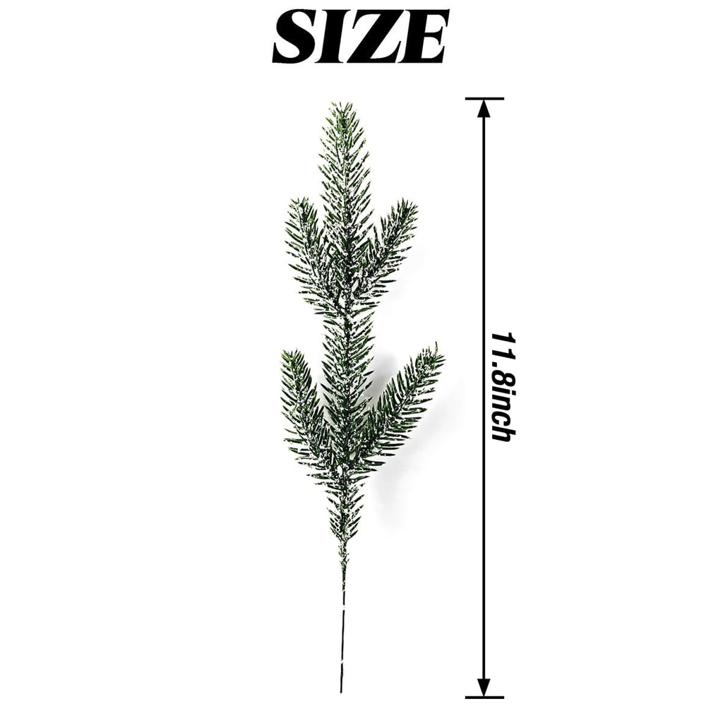 Artificial pine branch with snow-like dusting, shown with size indicator.