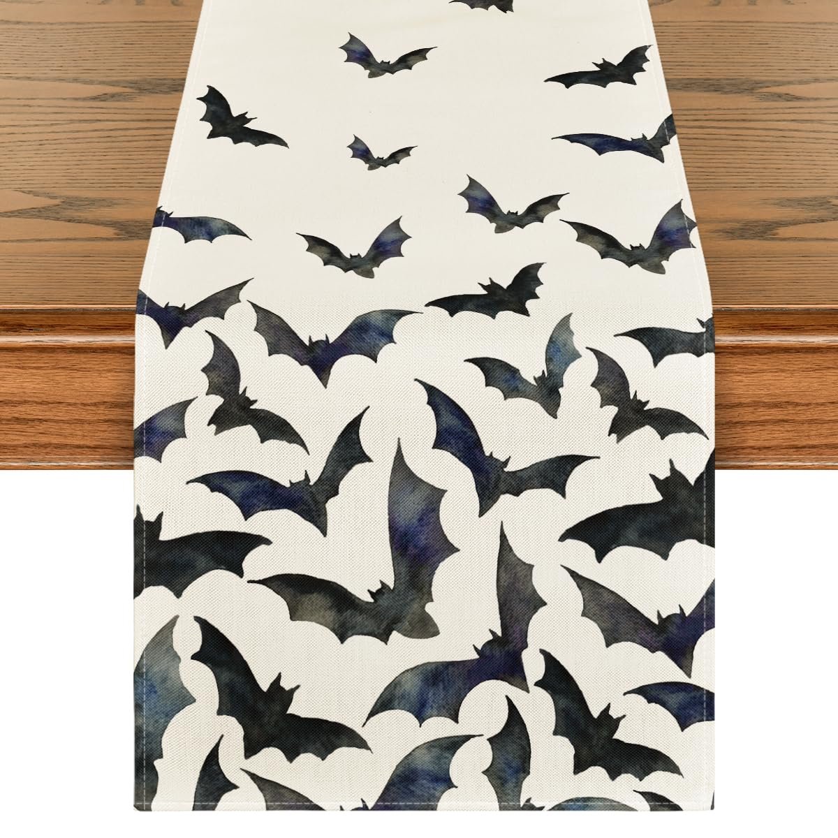 Black bats Halloween table runner on a wooden table, top-down view
