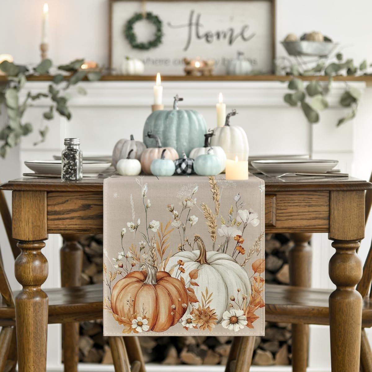 Fall table runner with pumpkins and floral print displayed on a wooden table with place settings and pumpkins on a mantelpiece.