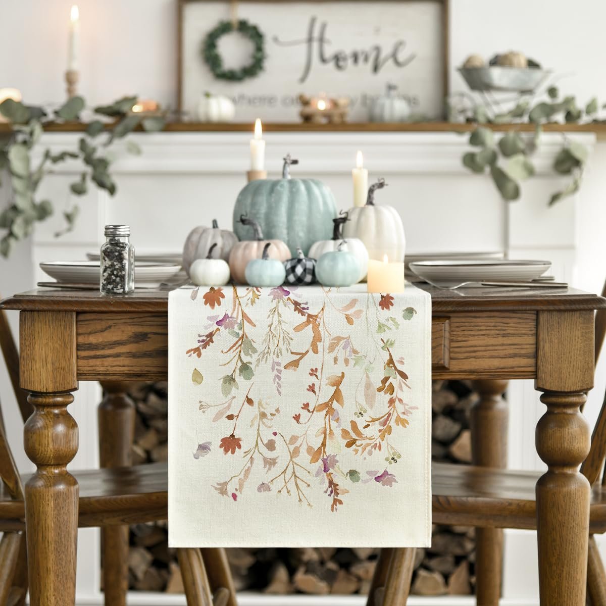 Fall table runner with floral leaves pattern on a decorated dining table with pumpkins and candles