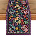 Sugar skull and floral patterned table runner on a wooden table