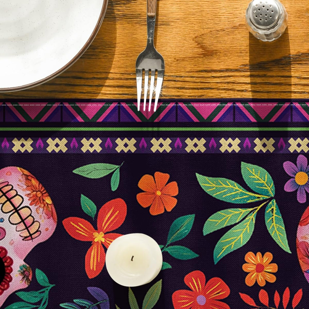 Table runner with sugar skull and floral pattern on a wooden table with a plate and fork