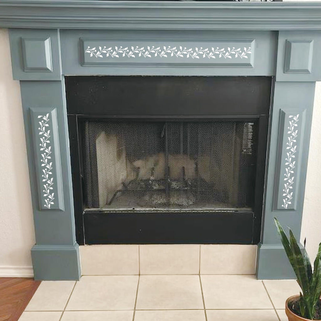 Fireplace surround decorated with white vine leaf stencils on the mantel and sides.