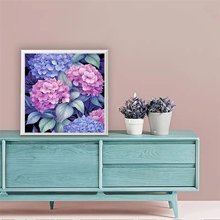 Diamond painting kit featuring pink and purple hydrangeas displayed on a teal dresser with potted plants.