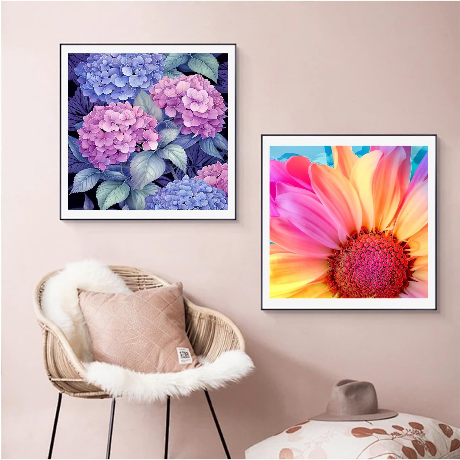 Two framed diamond paintings of flowers, one of hydrangeas and one of a dahlia, displayed on a wall above a chair.