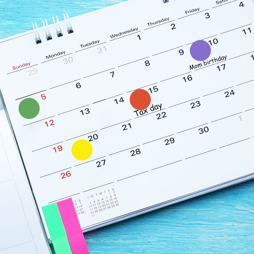 Color coding dot stickers applied to a calendar page, marking Tax day and Mom's birthday.