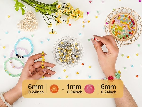 Hands creating bracelets with colorful glass beads and accessories, showing bead sizes.