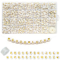 White acrylic letter beads with gold lettering and a heart charm, arranged in a storage box and as a string spelling 'GOOD LUCK'.