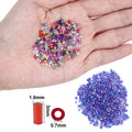 Hand holding colorful bugle glass seed beads next to a pile of blue beads, with size dimensions shown for one bead.
