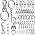 Assortment of silver-tone keychain making supplies including lobster clasps, key rings, lanyard clips, and jump rings on a white background.