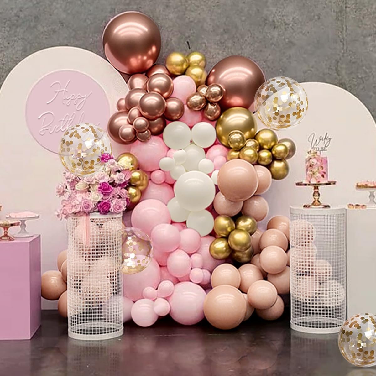 Rose gold, gold, white, and pastel pink balloon arch with confetti balloons for a party decoration.