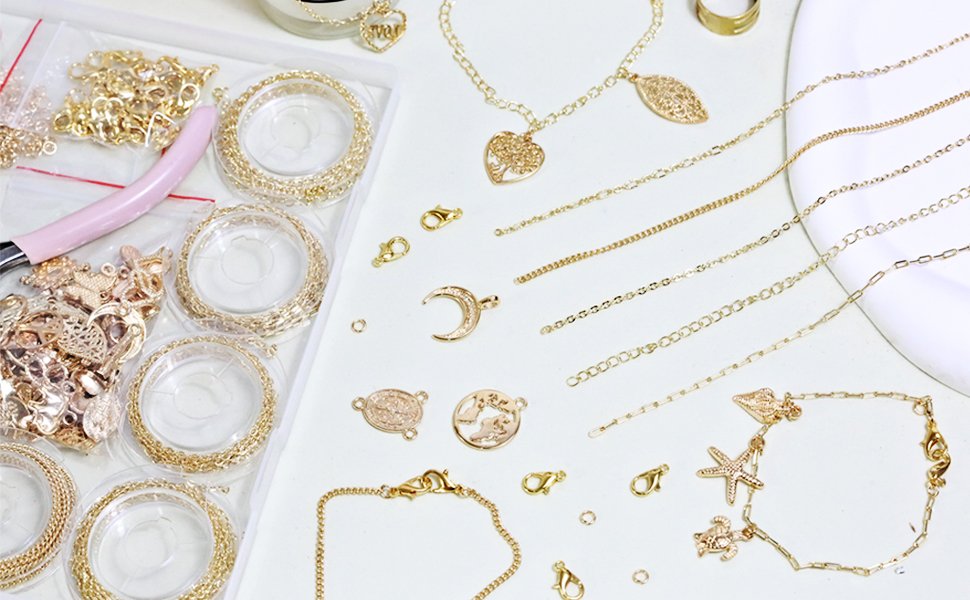 Gold jewelry making kit components including chains, charms, clasps, jump rings, and pliers laid out on a white surface.
