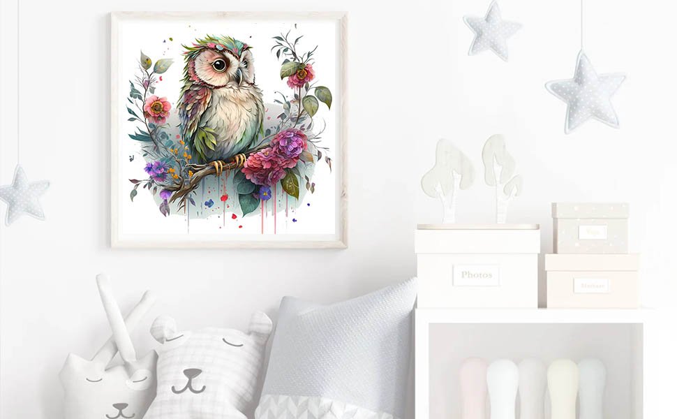 Framed owl art with flowers on a branch, displayed in a nursery setting with stuffed animals and storage boxes.