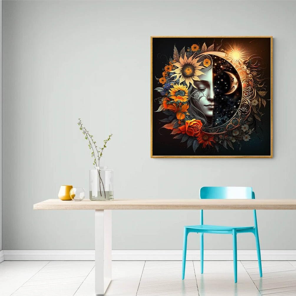 Framed diamond art painting of a woman's face split between sun and moon motifs, surrounded by flowers, hanging on a wall above a table.